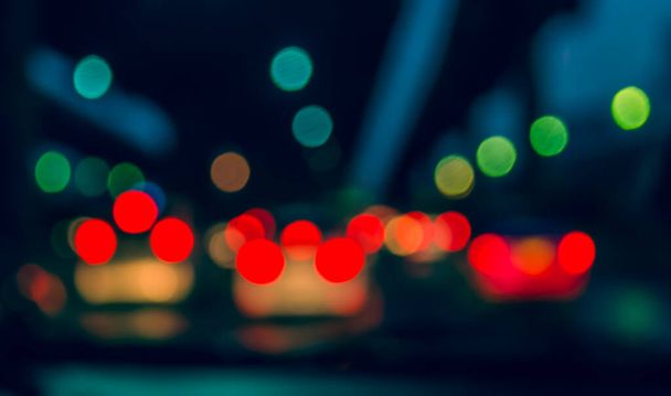 vintage tone blur image of inside cars with bokeh lights from traffic jam on night time for background. - Fotografie, Obrázek