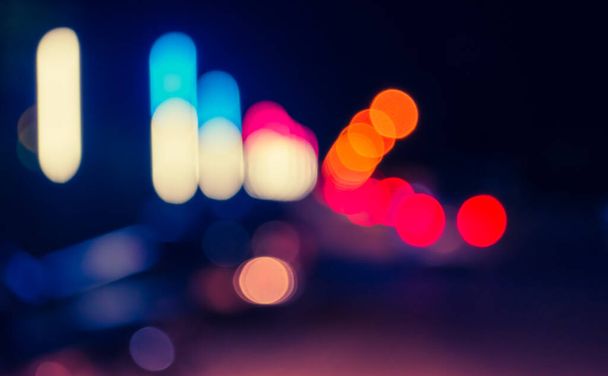 image of blur street bokeh with colorful lights in night time for background usage . (vintage tone) - Valokuva, kuva