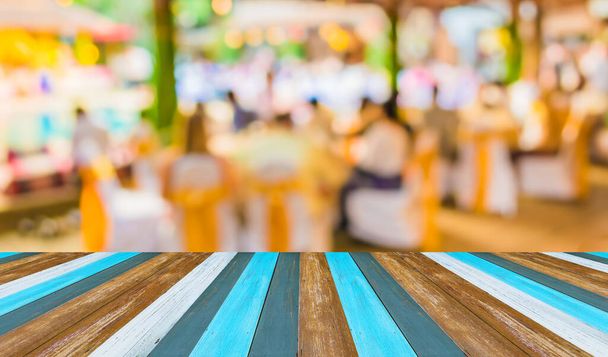 Abstract blurred image of Large dining table set for wedding, dinner or festival event with beautiful lights decoration inside large hall for background usage . - Photo, Image