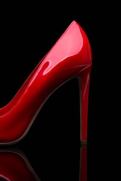 High heel of red shoes on a black background - Foto, afbeelding