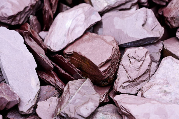 Close up of decorative plum coloured slate pieces in a garden. No people. - Photo, Image