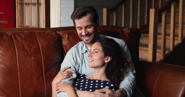 Couple in love relaxing on couch cuddling enjoy pleasant talk - Felvétel, videó