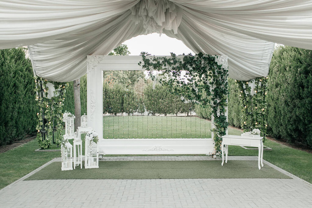 outside wedding white wall. green garden decor with drapings  - Photo, Image