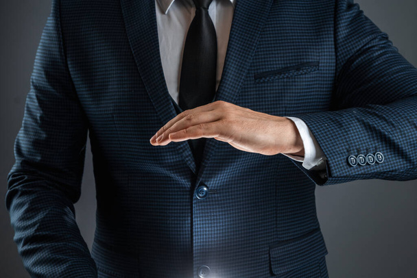 A man in a business suit shows a palm down gesture. Stock for business concept. Close-up, copy space - Foto, afbeelding