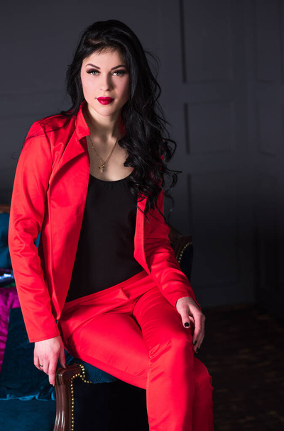 Brunetka w czerwonym garniturze. Modny zmysłowy nowoczesny wygląd, ładny styl biznesowy - Zdjęcie, obraz