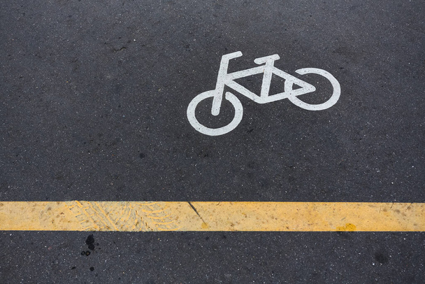 Image of Bicycle sign or icon on the road in the park. Bike path - Photo, Image