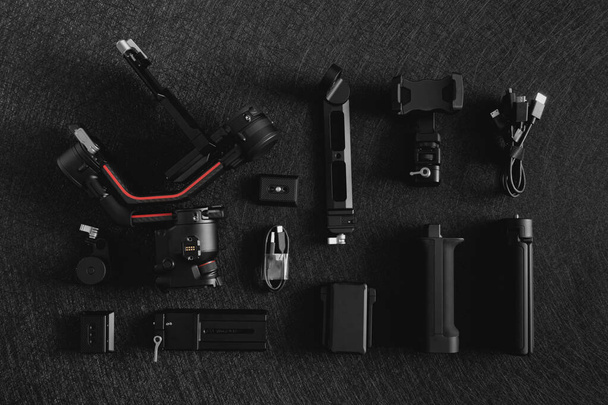 top view of work space photographer with digital camera, Gimbal Stabilizers and camera accessory - Foto, Imagen