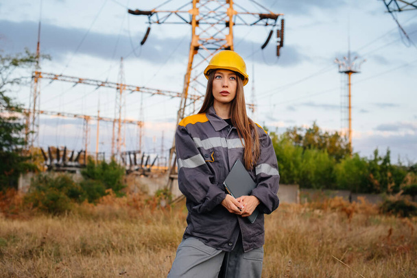 A young engineering worker inspects and controls the equipment of the power line. Energy - Fotoğraf, Görsel