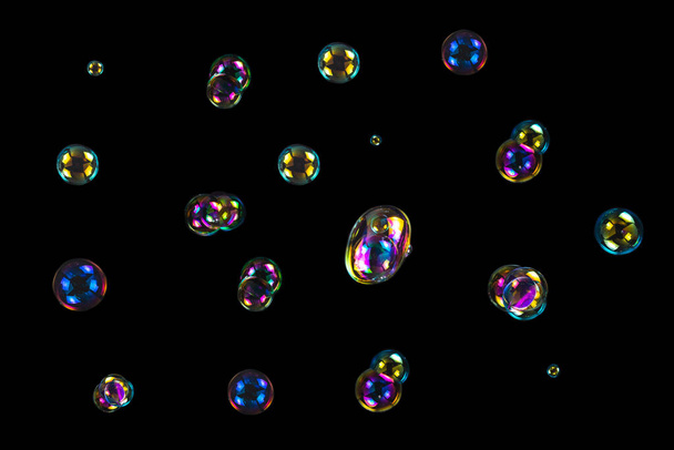 Soap bubbles isolated on a black background. Copy space.  - Photo, Image
