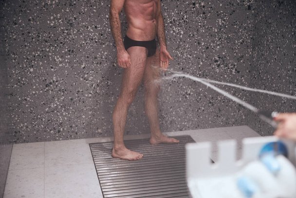 Man healing his legs with Charcot douche - Zdjęcie, obraz