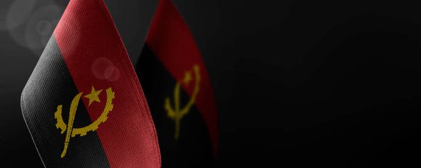 Small national flags of the Angola on a dark background - Photo, Image