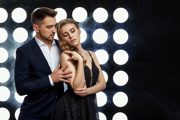 couple posing against the backdrop of spotlights - Zdjęcie, obraz
