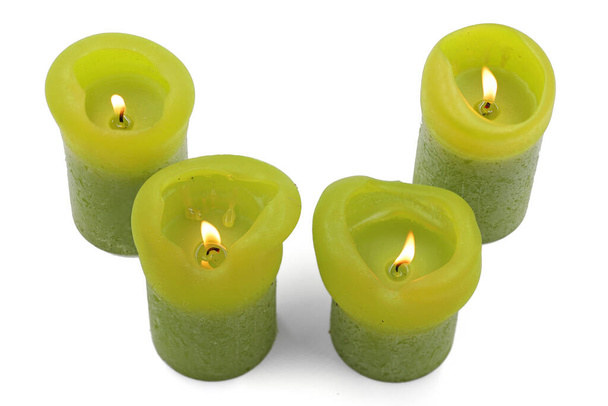 different sized burning green candles on a white background, top view - Photo, Image