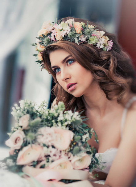 Portrait of a gentle bride with flowers. Beautiful tender bridal morning - Фото, изображение