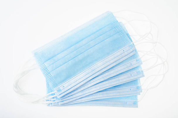 Blue medical disposable masks on white background, protection against coronavirus. Studio Photo - Photo, image