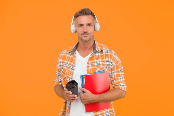 Never too late to study. Educational technology. Study again. Audio book concept. Worldwide knowledge access. Audio library. Another way of study. Man handsome college student headphones books - 写真・画像