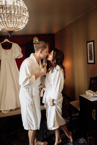 happy young  groom and  bride in bathrobes  - 写真・画像