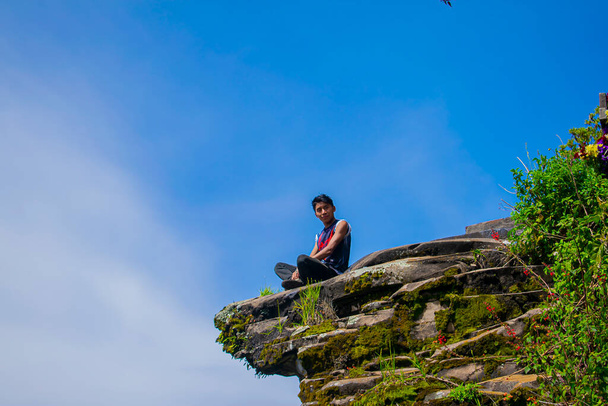 blue sky with young man sitting with beautiful blue sky - Фото, зображення