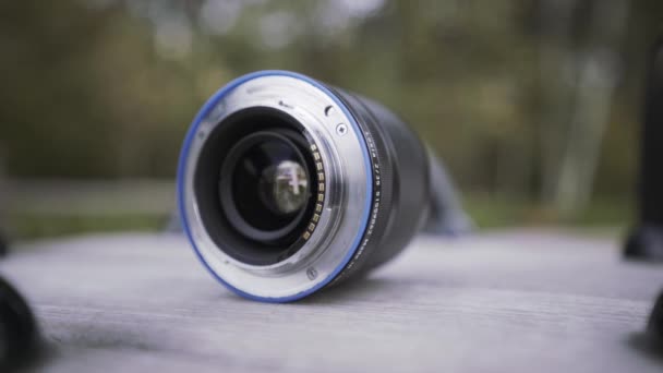 Close up of opened aperture on camera lens. Action. Camera lens, details of professional equipment for photo and video shooting on blurred background. - Footage, Video