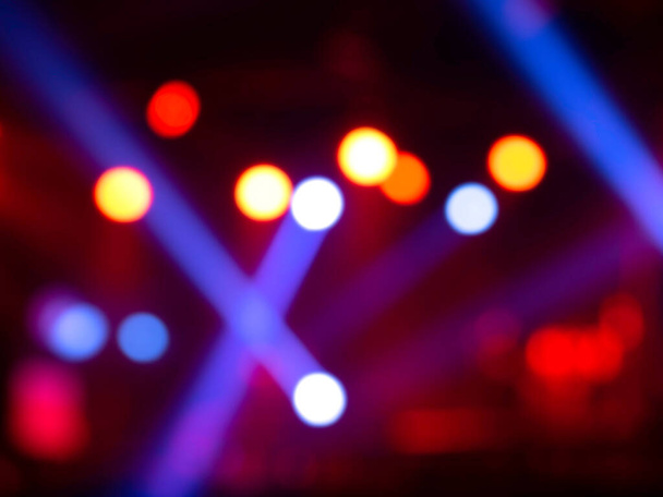 Blurred stage light concert background with colorful beam and laser rays on stage. Defocused entertainment show lighting bokeh. - Photo, Image