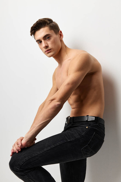 Handsome male nude torso black pants portrait studio isolated background - Foto, Imagem