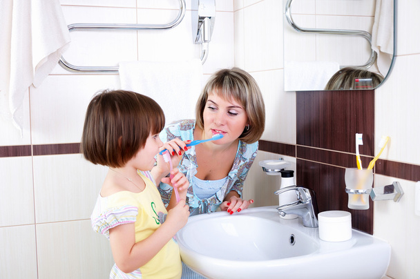 Mother and daughter brushing their teeth - Fotoğraf, Görsel
