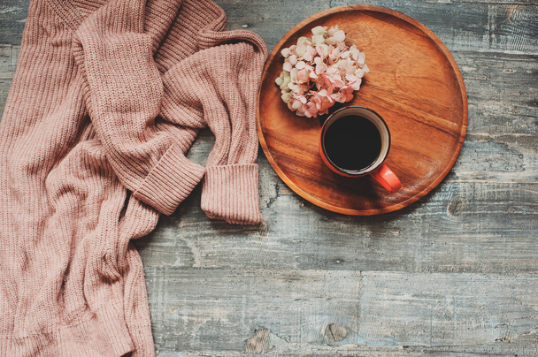 autumn or summer garden table top view with cozy sweater, coffee, dried hydrangea flowers on wooden background - Foto, immagini