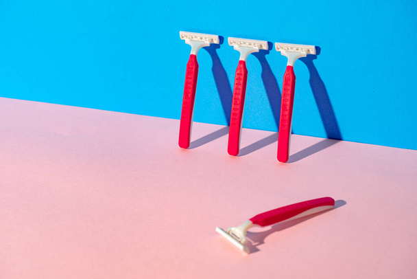 Disposable razor on blue and pink background - Photo, Image