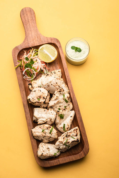 Indian Afghani chicken Malai Tikka is a grilled Murgh creamy kabab served with fresh salad - Photo, Image