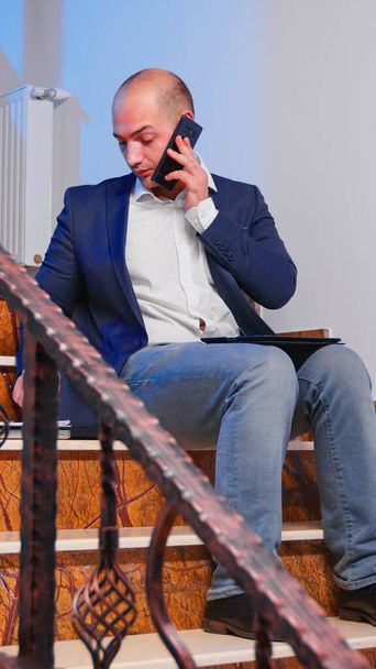 Businessman reading project deadline during phone call - Fotoğraf, Görsel