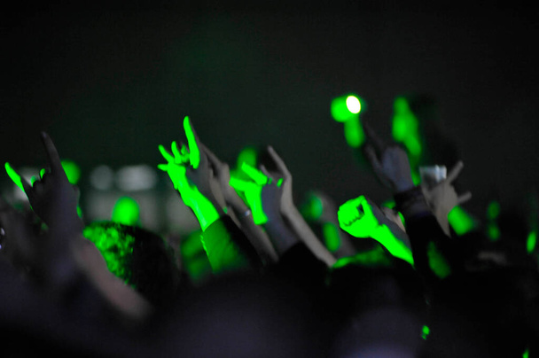 audience at a live concert cheering with hands in the air - Photo, Image