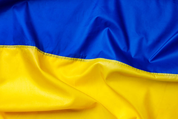 National flag of Ukraine fabric textile background - Foto, imagen