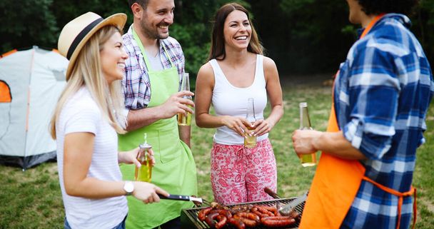 Friends having a barbecue party in nature while having a blast - Fotoğraf, Görsel