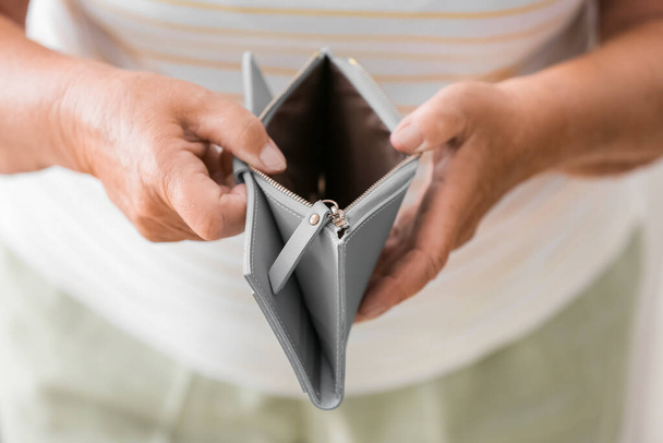 Senior woman showing empty wallet, closeup. Concept of pension - Photo, Image