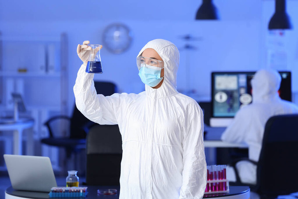 Scientist studying sample in laboratory - Фото, изображение