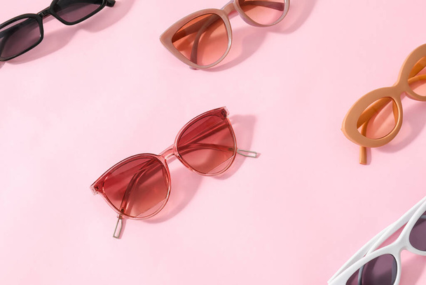 Stylish sunglasses on color background - 写真・画像