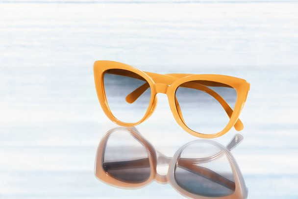 Stylish sunglasses on color background - Photo, Image