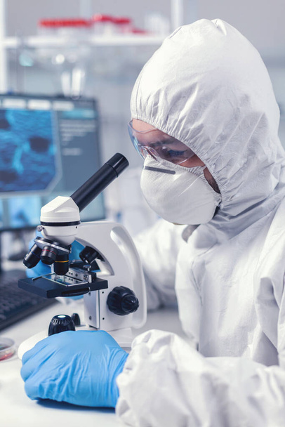 Close up of chief researcher scientist adjusts microscope - Photo, Image