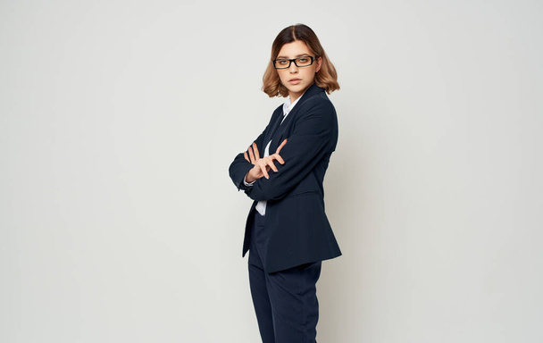 Business woman in a blue jacket and trousers on a light background cropped with Model - Foto, imagen