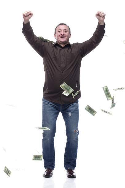 in full growth. happy man standing in the rain of money . - Valokuva, kuva
