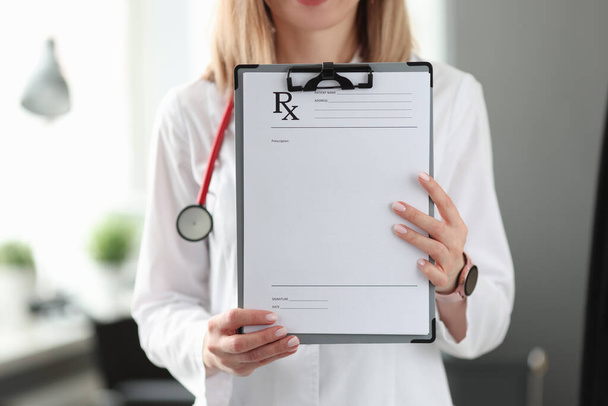 Female doctor therapist holding prescription blank closeup - 写真・画像