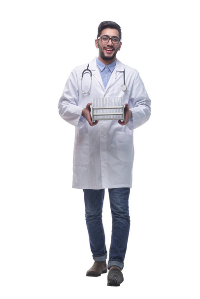 doctor with test tubes striding forward. isolated on a white background. - Foto, imagen