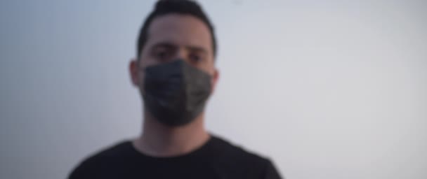 A young man in a black mask holding a vaccine - Footage, Video