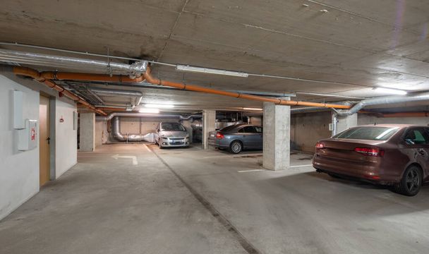 Cars on underground parking in modern residential complex. - Photo, Image