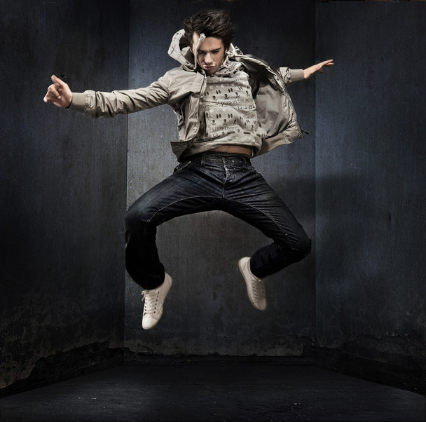 Young hip-hop dancer over a grunge wall - Фото, изображение