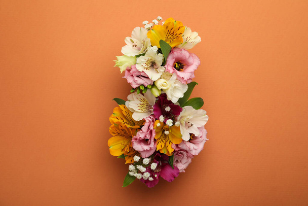 Number 8 made of beautiful flowers on orange background, flat lay. International Women's day - Foto, afbeelding