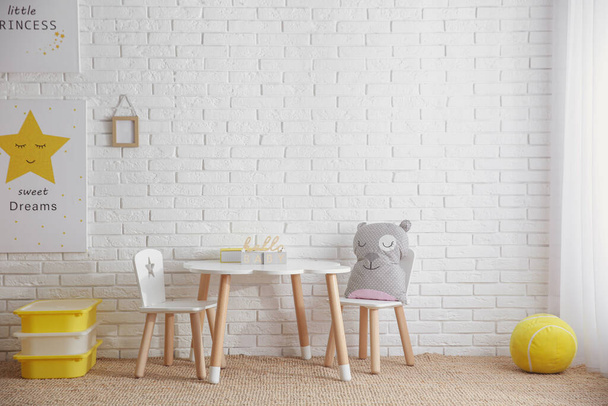 Baby room interior with toys and stylish furniture, space for text - Фото, зображення