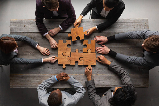 Business teamwork with puzzle finishing project cooperation unity concept - Fotó, kép