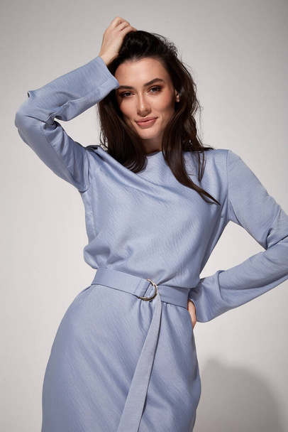 sexy brunette woman luxury lifestyle bright makeup wear natural organic blue silk midi dress high heels perfect body shape fashion model style for meeting party romantic date studio grey background. - 写真・画像