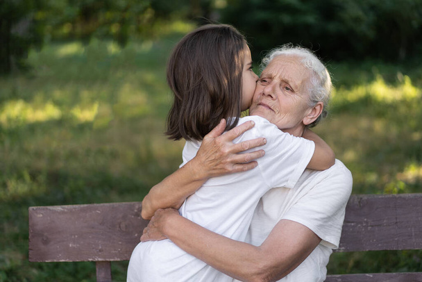Affectionate granddaughter and grandmother are hugging. I love you. - Foto, Imagem